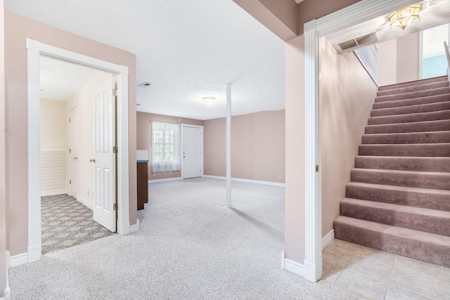 staircase featuring carpet and baseboards