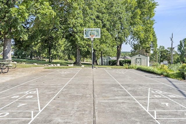 view of basketball court featuring a shed