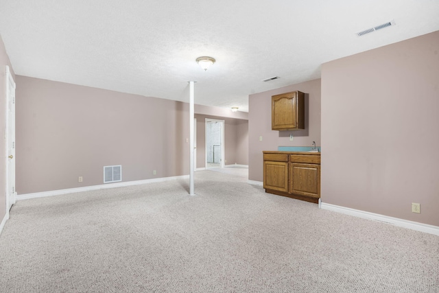 unfurnished living room with light colored carpet and baseboards