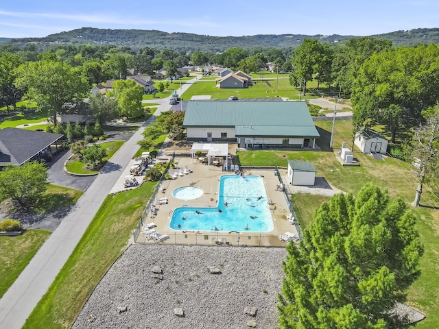 view from above of property with a pool area and a mountainous background