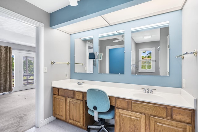 bathroom featuring ceiling fan, plenty of natural light, double vanity, and tile patterned flooring