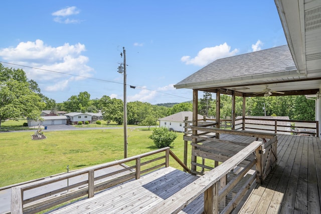 wooden terrace featuring a lawn and a ceiling fan