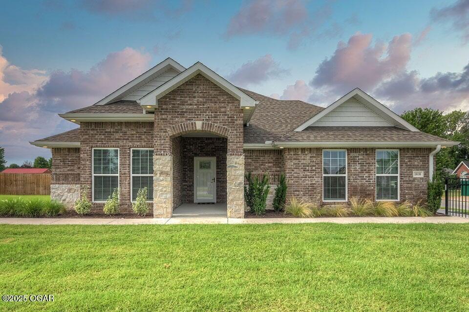 1818 W Fountain Rd, Webb City, MO 64870 - view of front facade with roof with shingles and brick siding