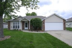 ranch-style home featuring concrete driveway, a front lawn, and an attached garage