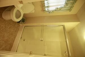 bathroom with a shower with shower door