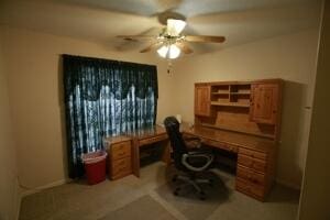 office with a ceiling fan and built in desk