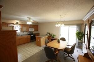 dining space with a ceiling fan and a chandelier