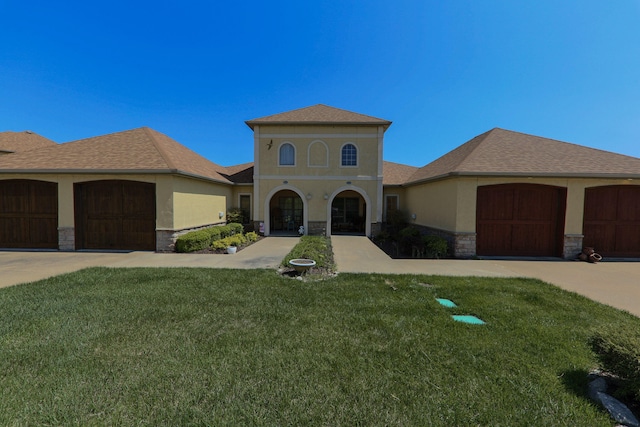 134 Monte Christo Dr, Hollister, MO 65672 - mediterranean / spanish-style home with stucco siding, an attached garage, stone siding, a front yard, and driveway