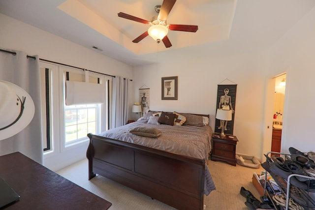 134 Monte Christo Dr, Hollister, MO 65672 - bedroom with carpet, a tray ceiling, ceiling fan, and ensuite bathroom