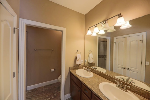 134 Monte Christo Dr, Hollister, MO 65672 - full bathroom with toilet, marble finish flooring, double vanity, and baseboards