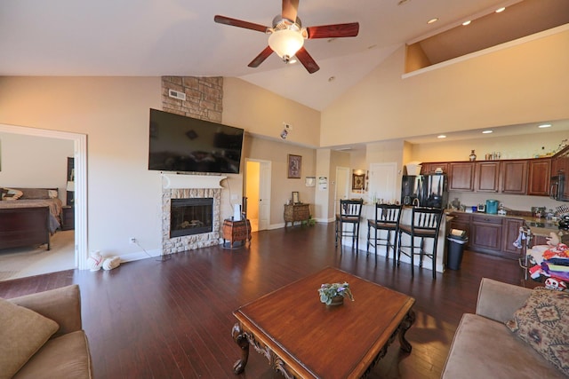 134 Monte Christo Dr, Hollister, MO 65672 - living room with a ceiling fan, high vaulted ceiling, a fireplace, dark wood-style floors, and recessed lighting