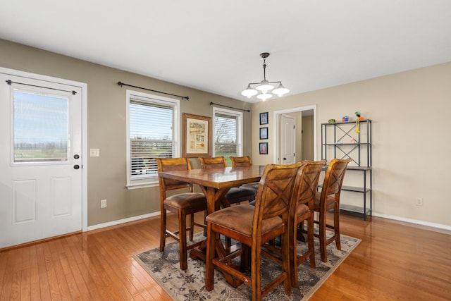 12048 N Farm Road 93, Walnut Grove, MO 65770 - dining room with light wood finished floors, a chandelier, and baseboards