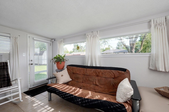 living area with a textured ceiling and tile patterned floors