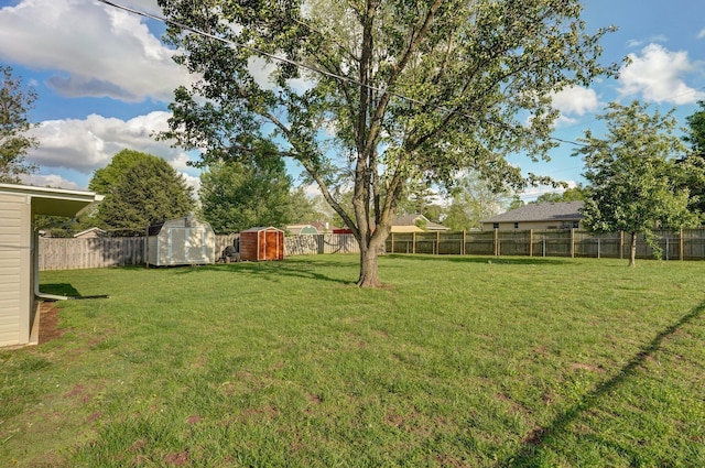 view of yard featuring a shed and an outdoor structure