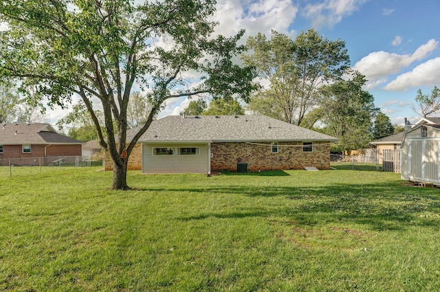 back of property with brick siding, an outbuilding, and a shed