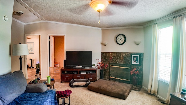 1156 SE 180th Rd, Clinton, MO 64735 - carpeted living room with a textured ceiling, a tile fireplace, ceiling fan, and ornamental molding