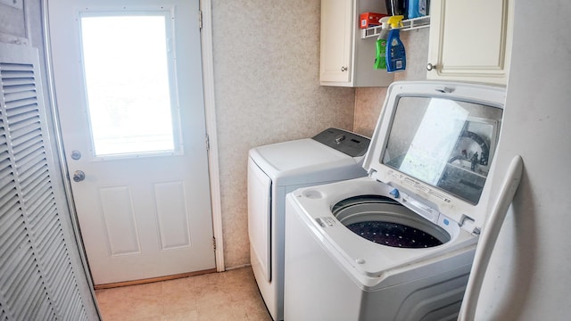 1156 SE 180th Rd, Clinton, MO 64735 - laundry room featuring washing machine and dryer, cabinet space, and light tile patterned flooring
