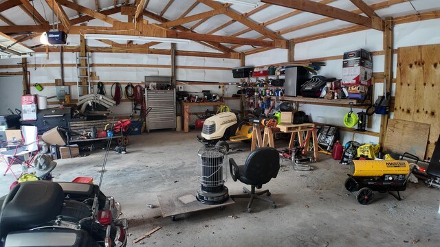 1156 SE 180th Rd, Clinton, MO 64735 - garage with a workshop area, water heater, and a garage door opener