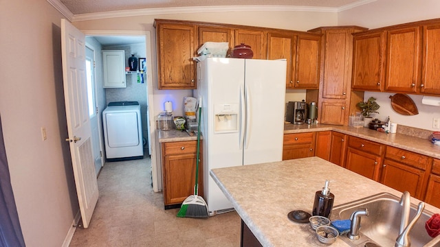 1156 SE 180th Rd, Clinton, MO 64735 - kitchen with white fridge with ice dispenser, washer / dryer, brown cabinetry, light flooring, and ornamental molding