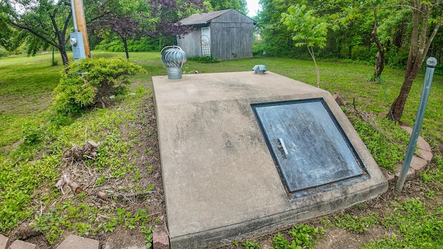 1156 SE 180th Rd, Clinton, MO 64735 - entry to storm shelter featuring a lawn, a storage shed, and an outdoor structure