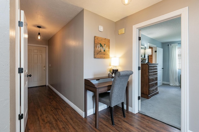 hallway with dark wood-style flooring and baseboards