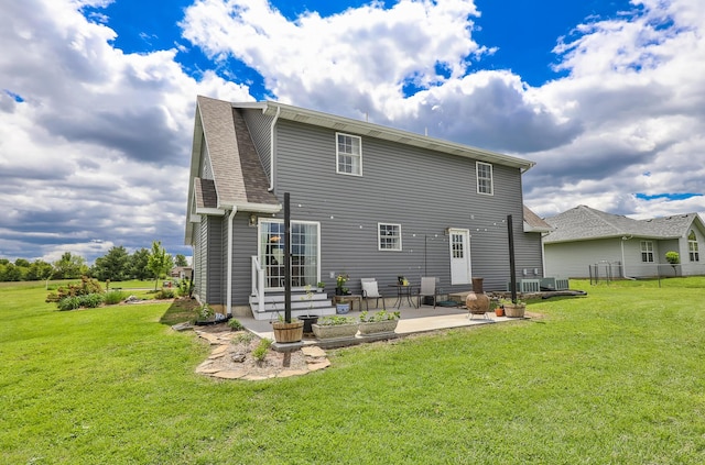 rear view of property featuring a patio and a yard