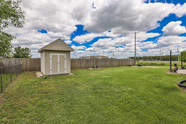 view of yard featuring a shed and an outbuilding