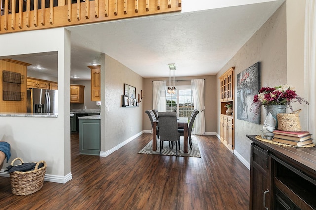 dining space featuring dark wood-type flooring and baseboards