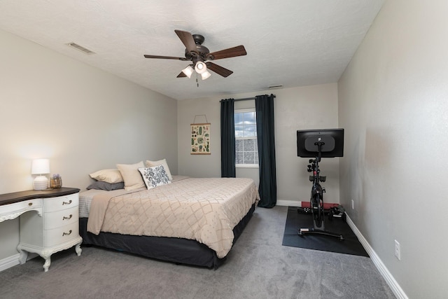 carpeted bedroom with baseboards and a ceiling fan