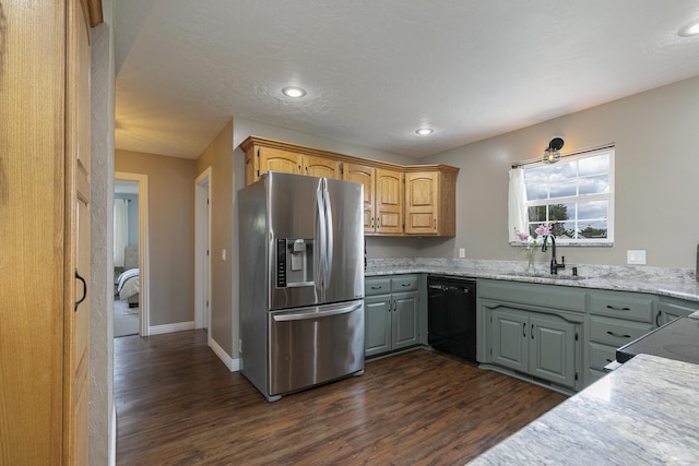 kitchen featuring stainless steel fridge with ice dispenser, a sink, dishwasher, dark wood-style floors, and recessed lighting
