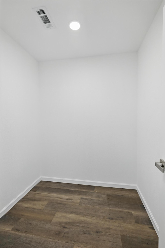 spare room with baseboards, recessed lighting, and dark wood-style floors