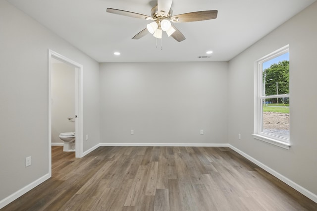 empty room featuring wood finished floors, baseboards, ceiling fan, and recessed lighting