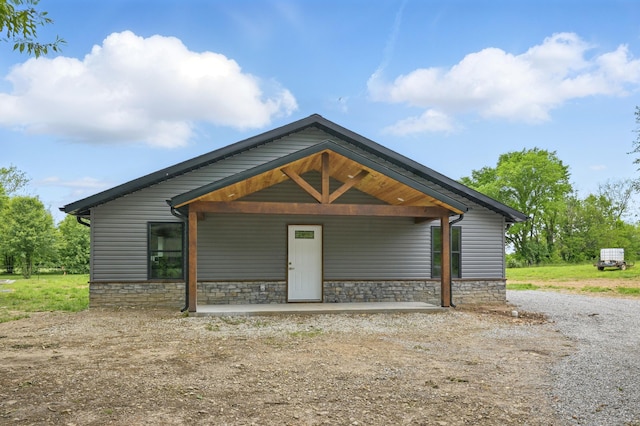 bungalow-style house featuring stone siding