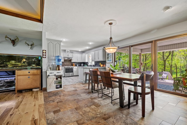 dining space with a textured ceiling and recessed lighting