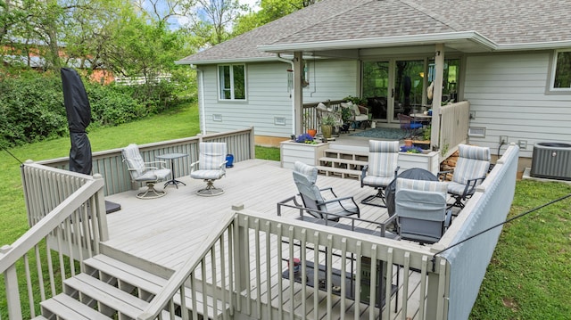wooden terrace featuring central AC, a yard, and outdoor dining space
