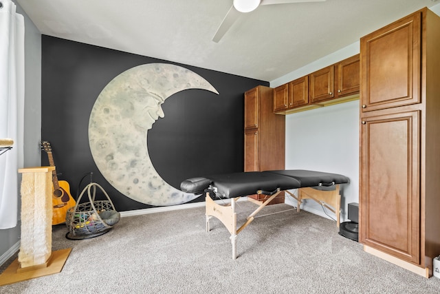 carpeted office featuring ceiling fan and baseboards