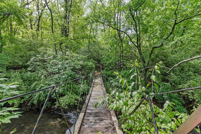 surrounding community featuring a wooded view