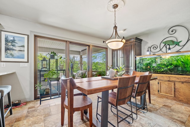 dining space featuring stone tile flooring