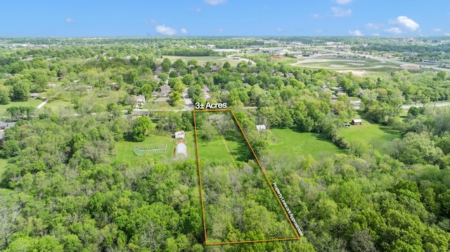 aerial view of property and surrounding area featuring property parcel outlined