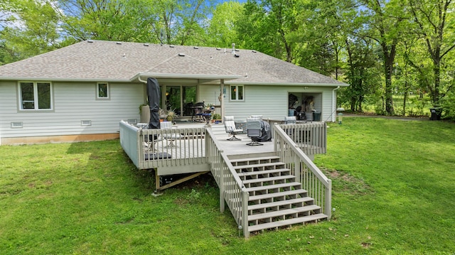 rear view of property with a shingled roof, a yard, stairs, and a wooden deck