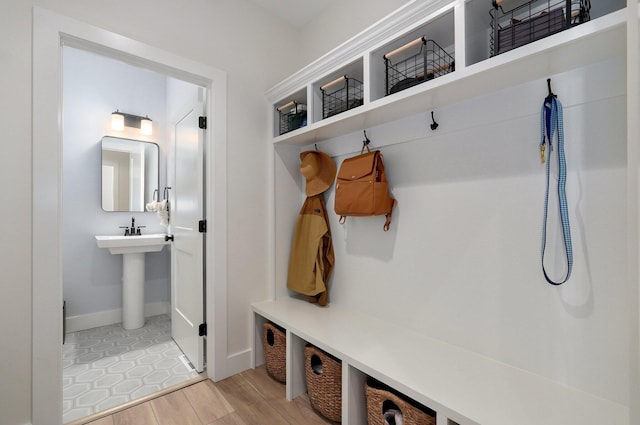 mudroom with baseboards and light wood finished floors