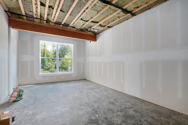 unfurnished room with concrete floors