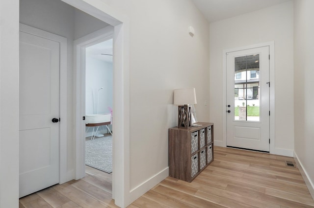 entryway with light wood-style flooring and baseboards