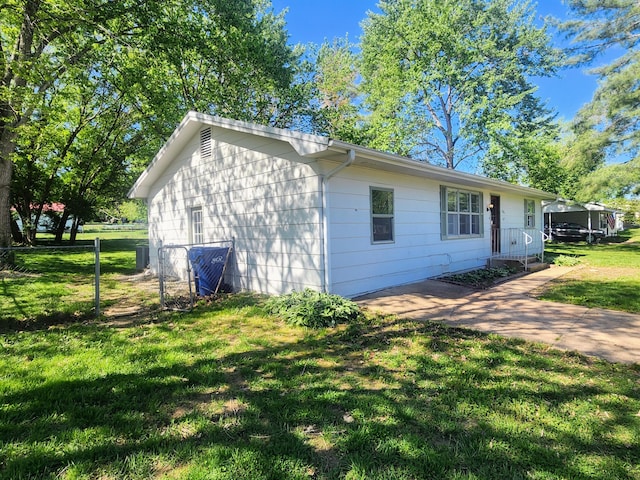 view of side of home featuring central AC