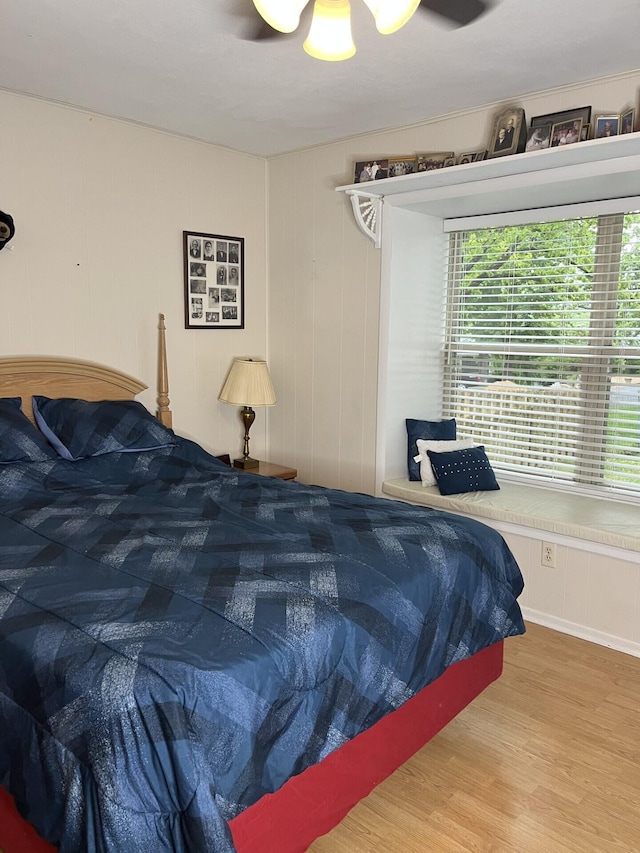 bedroom with wood finished floors and a ceiling fan