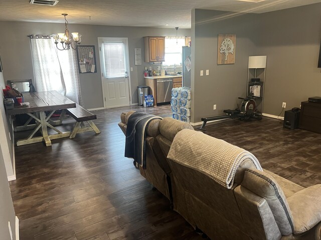 156 Southern Cross Dr, Clever, MO 65631 - living area featuring a chandelier, dark wood-type flooring, and baseboards