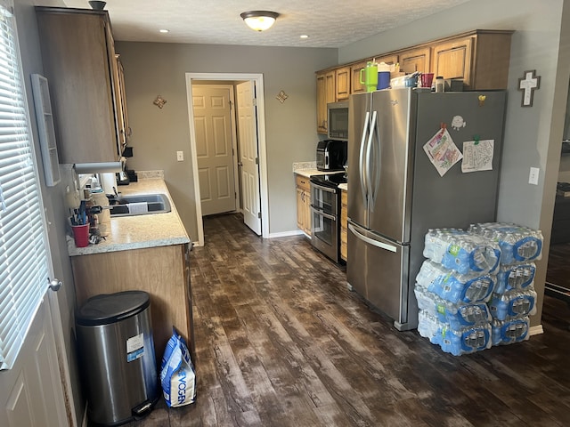 156 Southern Cross Dr, Clever, MO 65631 - kitchen with appliances with stainless steel finishes, a sink, light countertops, dark wood-style floors, and a textured ceiling