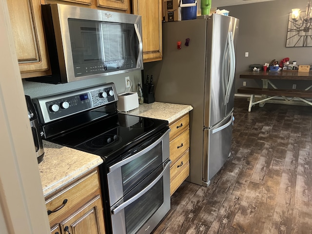 156 Southern Cross Dr, Clever, MO 65631 - kitchen featuring stainless steel appliances, brown cabinetry, and dark wood finished floors