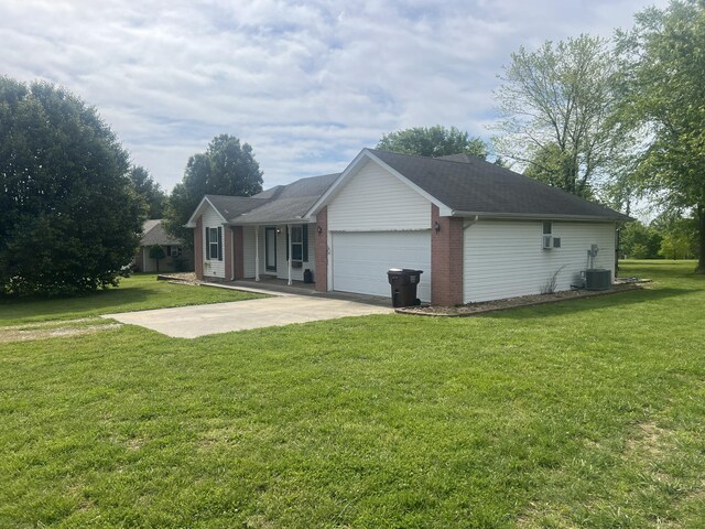 156 Southern Cross Dr, Clever, MO 65631 - ranch-style home with a front yard, an attached garage, driveway, and central air condition unit