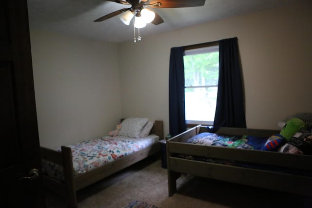 bedroom with multiple windows, carpet flooring, and ceiling fan